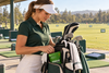 Golfer organizing her golf bag with a small green ZYLO Focus packet in the side pocket.
